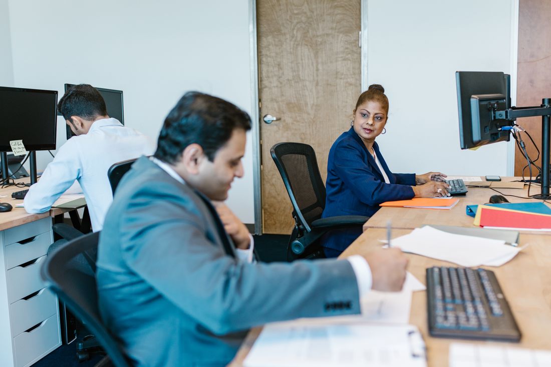 Colleagues working at their desks in an office